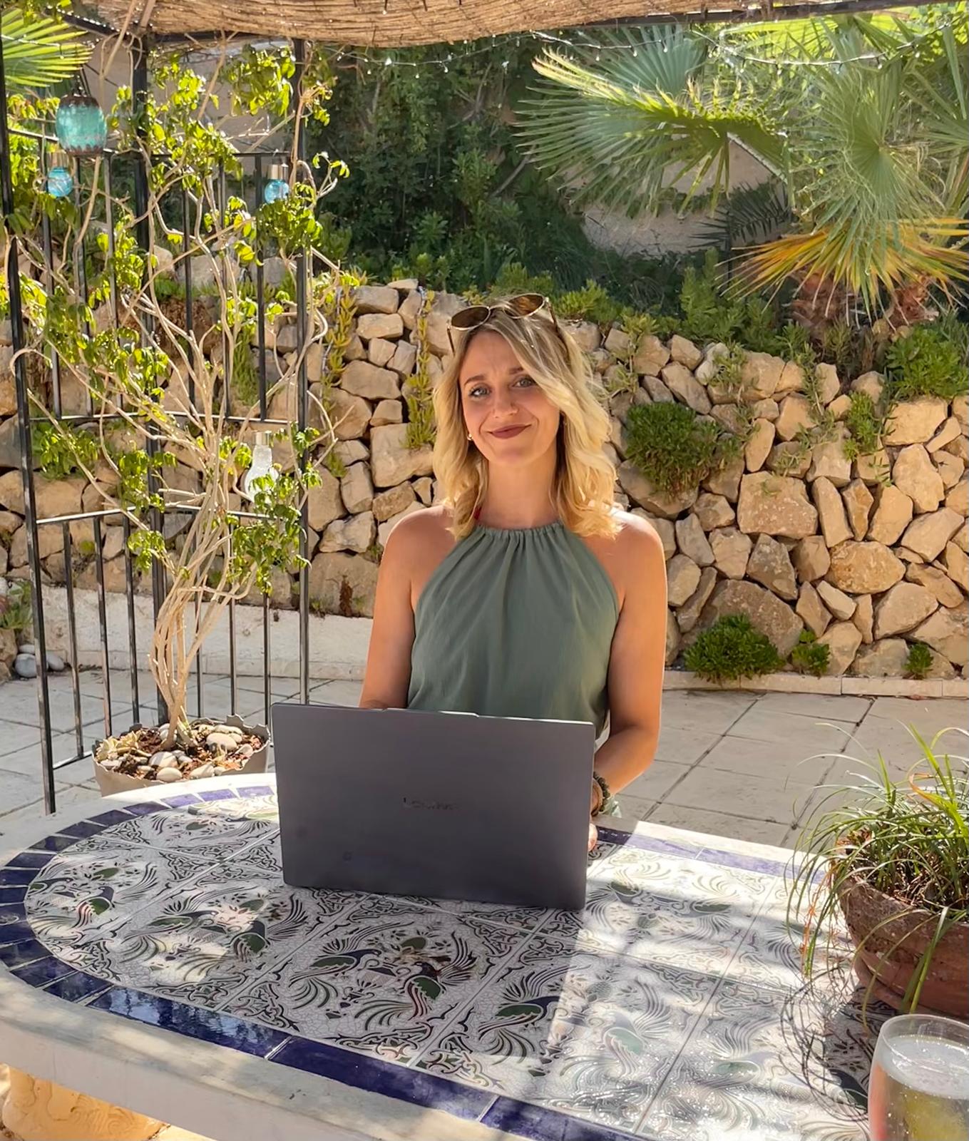 A Tax Help Spain adviser working on a laptop on a sunlit Spanish terrace